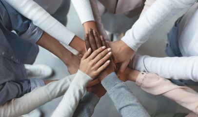 Team placing hands in circle