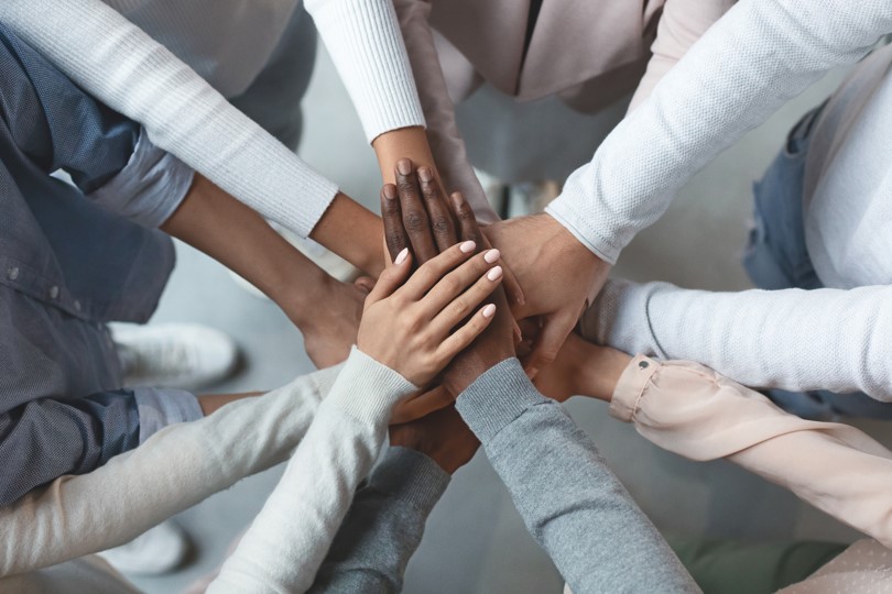 Team placing hands in circle